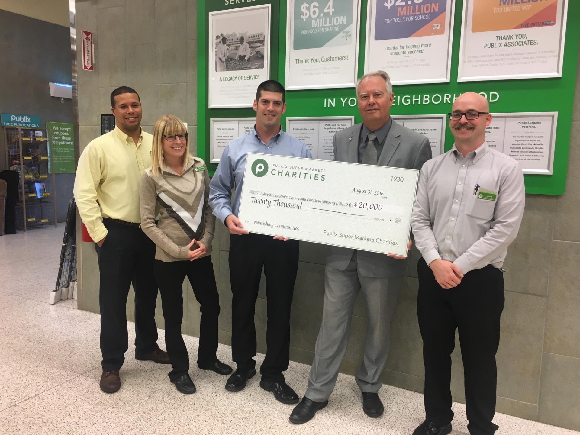 Reverend Scott Rogers, ABCCM's executive director (second from right) accepts a donation from Publix Super Markets Charities along with (left to right) David Yancy, grocery manager;&nbsp;Danielle Meyer,&nbsp;assistant customer service manager;&nbsp;…